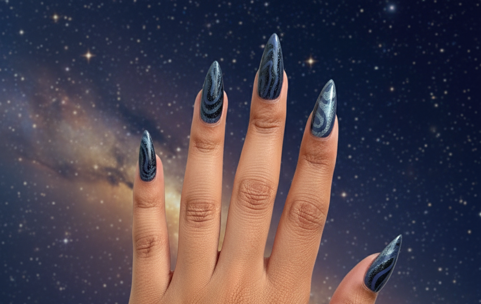 Hand with dark nail polish and a heart-shaped ring against a starry night sky background